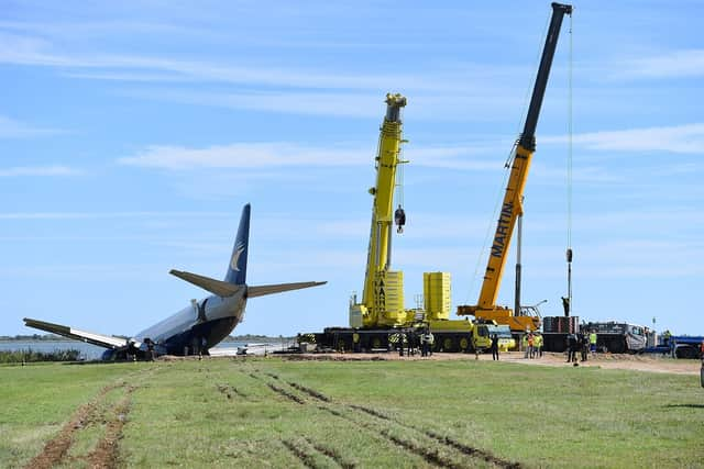 Cranes next to the Aeropostale Boeing 737 cargo plane after it overrun the runway during its night landing phase at Montpellier airport.