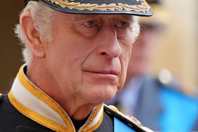 King Charles III follows the coffin of Queen Elizabeth II as it travels inside Windsor Castle on September 19.