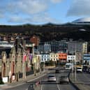 Cars travel by the seafront in St Helier, on the British island of Jersey