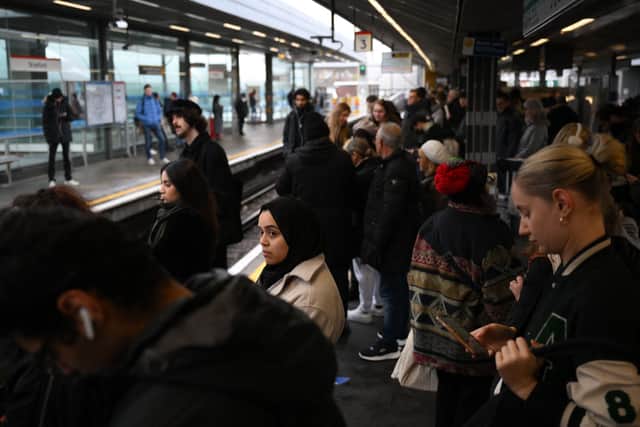 Commuters wait for an extremely delayed Central Line train at Stratford station in London on December 13  as rail strikes began a wave of festive walkouts in the country.