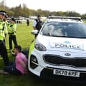 An animal rights protester is apprehended by police officers ahead of the Grand National. 