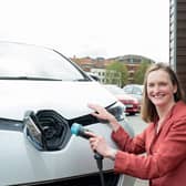 Angela Terry with EV charger to be a common sight outside all new build homes (photo: @JonCraig_Photos)