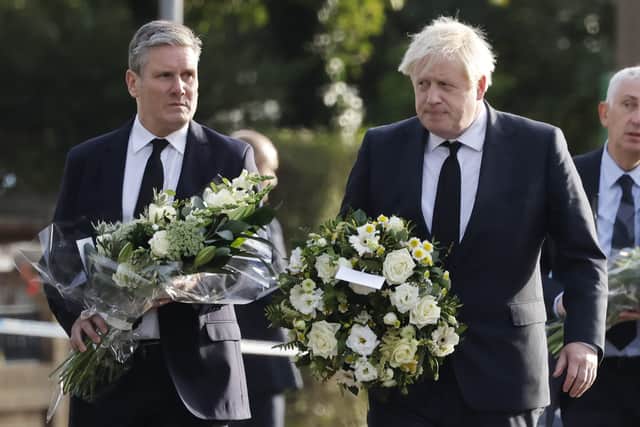 Prime Minister Boris Johnson and Labour leader Sir Keir Starmer laid floral tributes at the scene of Sir David Amess' fatal stabbing on Saturday (16 October) morning (image: AFP/Getty Images)