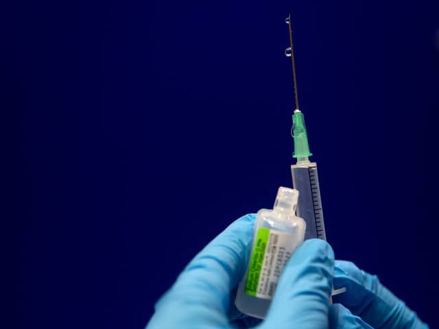 Sodium chloride is measured to be added to a phial of the Pfizer/BioNTech COVID-19 vaccine concentrate ready for administration at Guy’s Hospital in central London