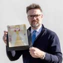 Charles Hanson, owner of Hansons Auctioneers, with a childhood drawing of Queen Elizabeth II drawn by a very young King Charles.  