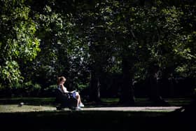 A woman reads a book on a bench in Green Park in central London on September 5, 2023 as the country experiences a late heatwave.