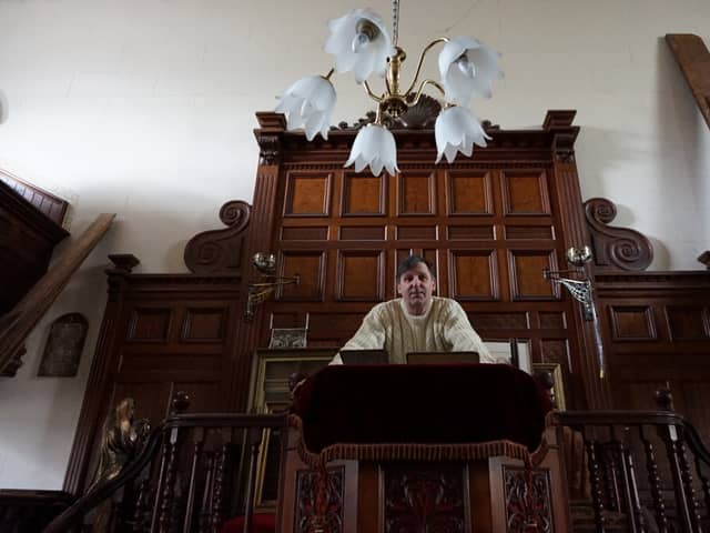 Wayne Colquhoun stands at the pulpit in the former Chapel Salem.