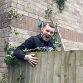 Amusing moment Tyla Shellard, 21, falls from an ivy branch whilst helping to clear a friends garden in Cardiff ready for summer, May 21 2024. 