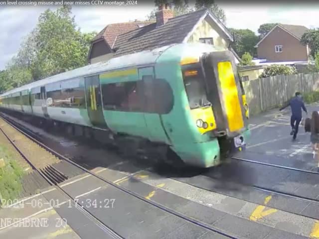 Shocking CCTV films the moment a girl risks her life at a level crossing, walking just a couples of metres in front of an advancing train.
