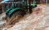 CCTV captures a tractor driving fast through floodwater in Tenbury Wells, Worcestershire.