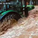 CCTV captures a tractor driving fast through floodwater in Tenbury Wells, Worcestershire.