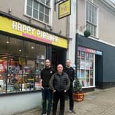 Happy Piranha store owner Martin Gaunt (centre) outside his store with sons Sam and Josh. 