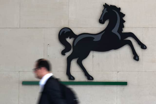 A man passes the entrance to a Lloyds Banking Group office in the City of London (Photo: JUSTIN TALLIS/AFP via Getty Images)