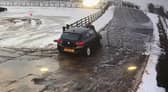 The moment Alan Lewis drove off with the staff member on the bonnet of the car. Credit: Mainsgill Farm Shop