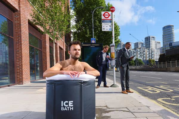 A commuter takes an ice bath at a London bus stop