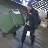 Reece Wheat drags the wheelie bin of stolen goods.