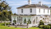 Merston House blends timeless Regency architecture with modern country living, complete with an orangery and sun-soaked patio for entertaining.