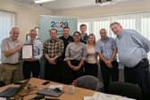 Ian (far left) receives his award certificate