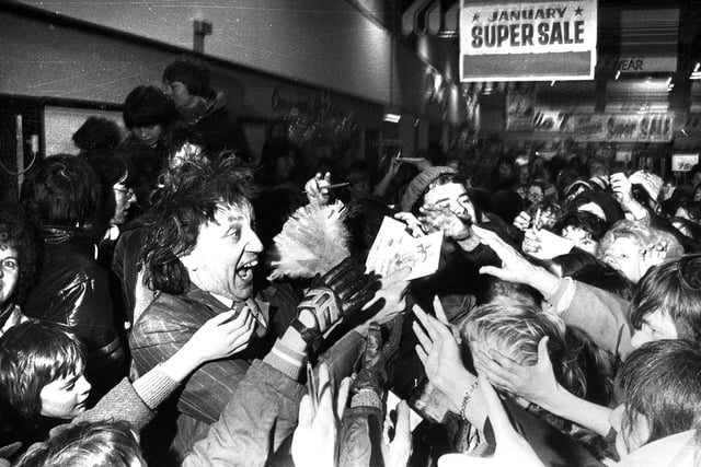 Comedian Ken Dodd is swamped by adoring fans at Hindley Co-Op in 1978