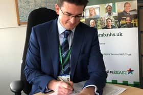 Dr Tom Davis signing the contract for the technology