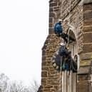 The Cumbria Clock Company abseil down St Mary’s Church with the clock in hand PHOTO: www.esmerobinson.com