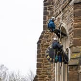 The Cumbria Clock Company abseil down St Mary’s Church with the clock in hand PHOTO: www.esmerobinson.com