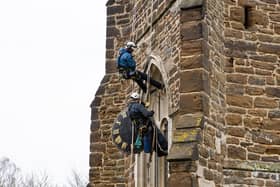 The Cumbria Clock Company abseil down St Mary’s Church with the clock in hand PHOTO: www.esmerobinson.com