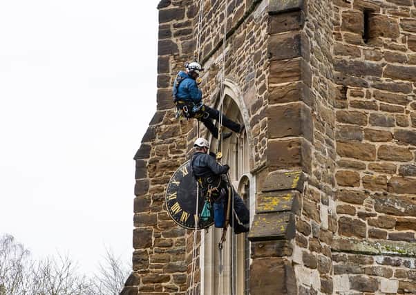 The Cumbria Clock Company abseil down St Mary’s Church with the clock in hand PHOTO: www.esmerobinson.com