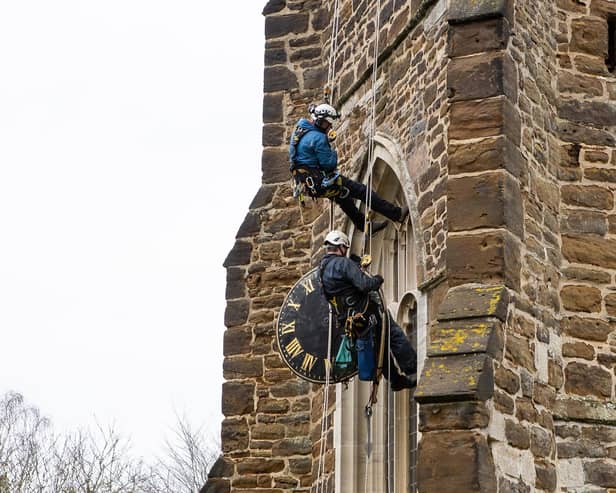 The Cumbria Clock Company abseil down St Mary’s Church with the clock in hand PHOTO: www.esmerobinson.com