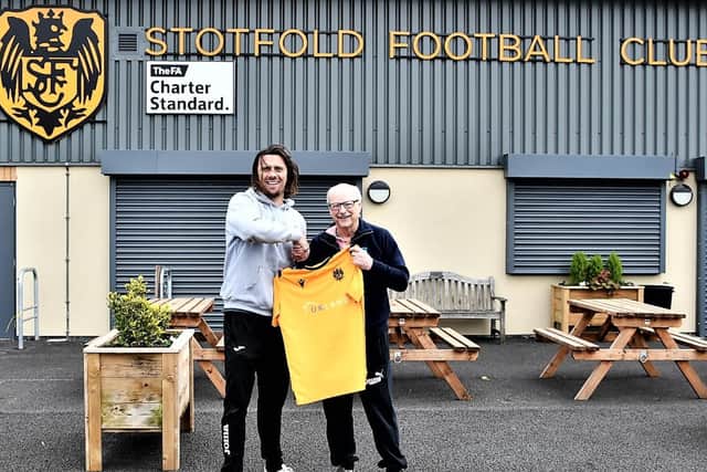 Happy times ahead: Brett Donnelly shakes hands with chairman Phil Pateman.
