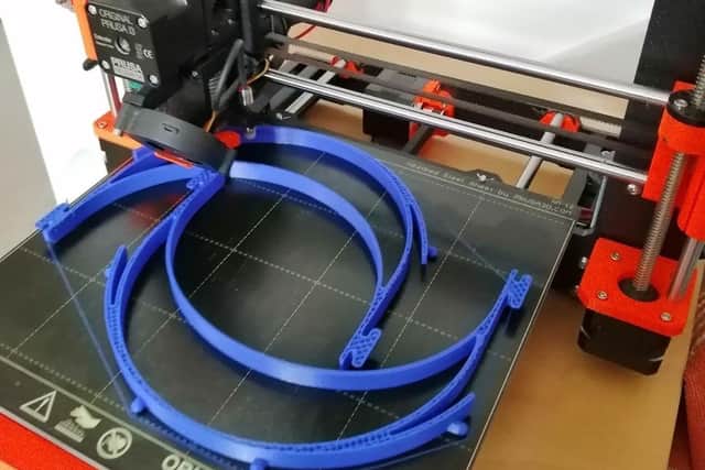 The 3D printed mask headbands, which David is making.