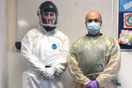 Critical Care Paramedic Nigel Strange and Doctor Rishi Rallan demonstrate the PPE they now need to wear to provide emergency pre-hospital care. (C) East Anglian Air Ambulance