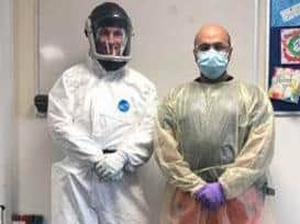 Critical Care Paramedic Nigel Strange and Doctor Rishi Rallan demonstrate the PPE they now need to wear to provide emergency pre-hospital care. (C) East Anglian Air Ambulance