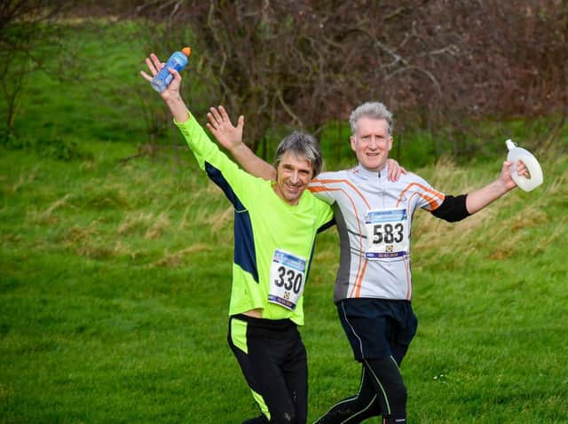 Phil (yelllow top) running in more companionable days with old school mate Jeremy Riggs: Picture by Ian Hawkes