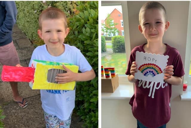 George with his guitar and a 'Hope' card that he made.