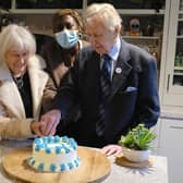 Iris and Ernest cut the celebratory cake
