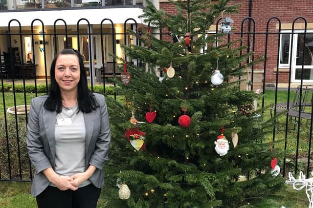 Fay Gooch pictured next to the tree