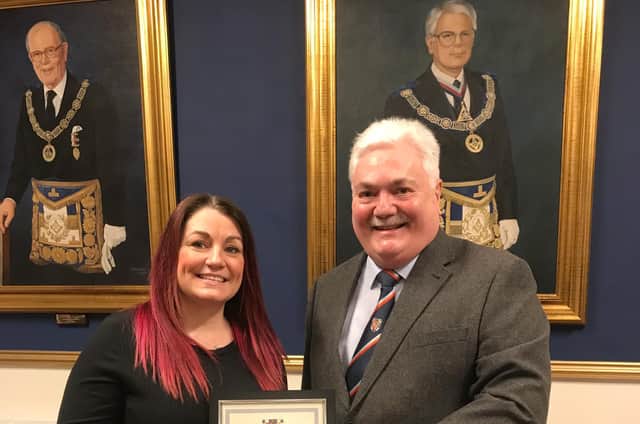 Pictured with Amy is Tony Henderson, Bedfordshire Freemasons current Provincial Grand Master, in front of a portrait of Martin Foss (right)