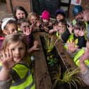 Children from Busy Bees show off their green fingers