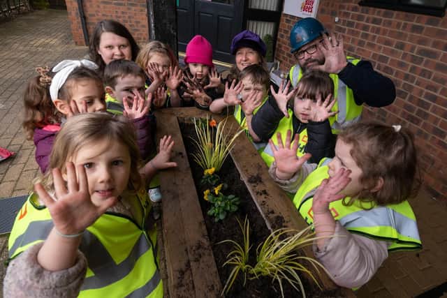 Children from Busy Bees show off their green fingers