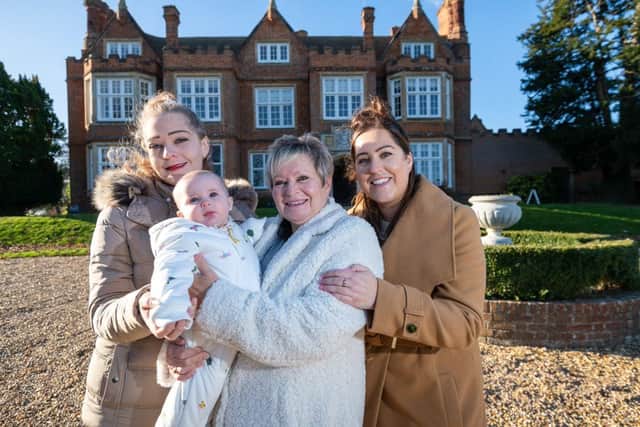 Angela Roberts with her daughters Becky (right) and Nikki (left) and granddaughter Cleo standing in front of Bourn Hall Clinic Cambridge.