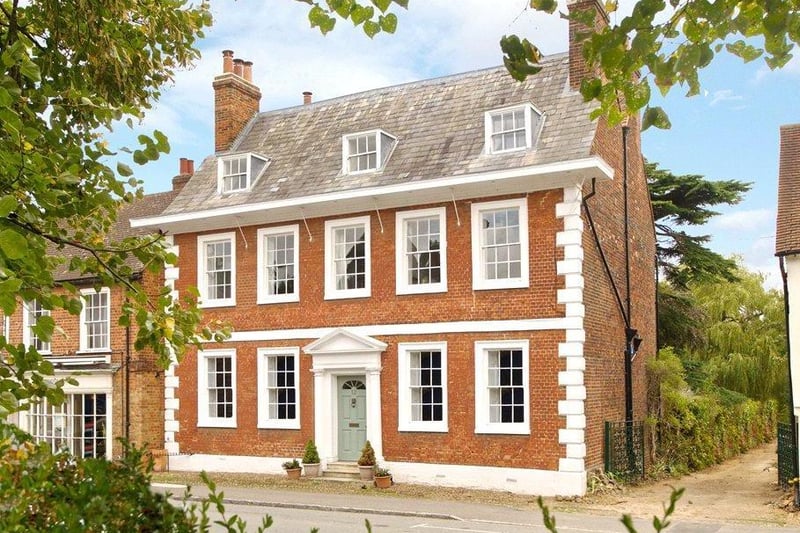 The symmetrical faade has five bays of sashed windows, with the front door situated in the middle bay on the ground floor.