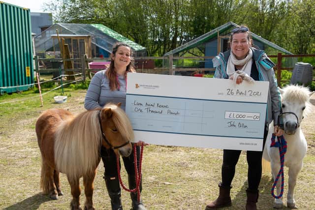 Natalie Howe (L) and Faye-Michelle Mallows (R) of Luna Animal Rescue with the cheque donated by David Wilson Homes.