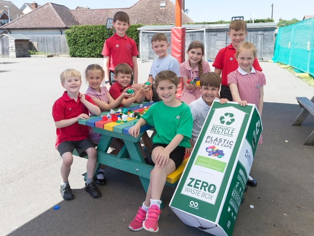 Children at the school enjoying the new bench