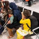 Afgan refugees wait to be processed after arriving on an evacuation flight from Afghanistan, at Heathrow Airport