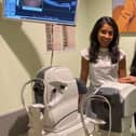 Store director Kamaljeet K Chana (RHS) and senior optometrist Nisha Shah (LHS)  standing next to a new OCT machine.