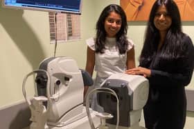 Store director Kamaljeet K Chana (RHS) and senior optometrist Nisha Shah (LHS)  standing next to a new OCT machine.