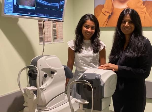 Store director Kamaljeet K Chana (RHS) and senior optometrist Nisha Shah (LHS)  standing next to a new OCT machine.