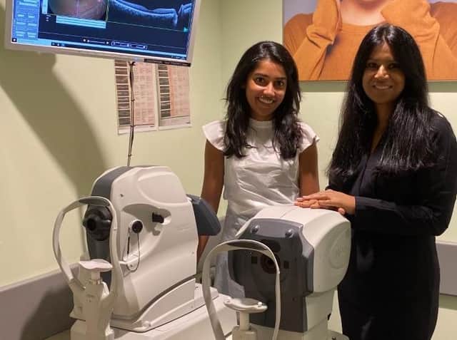 Store director Kamaljeet K Chana (RHS) and senior optometrist Nisha Shah (LHS) standing next to a new OCT machine.