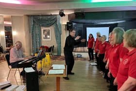 Douglas Coombes rehearsing the choir